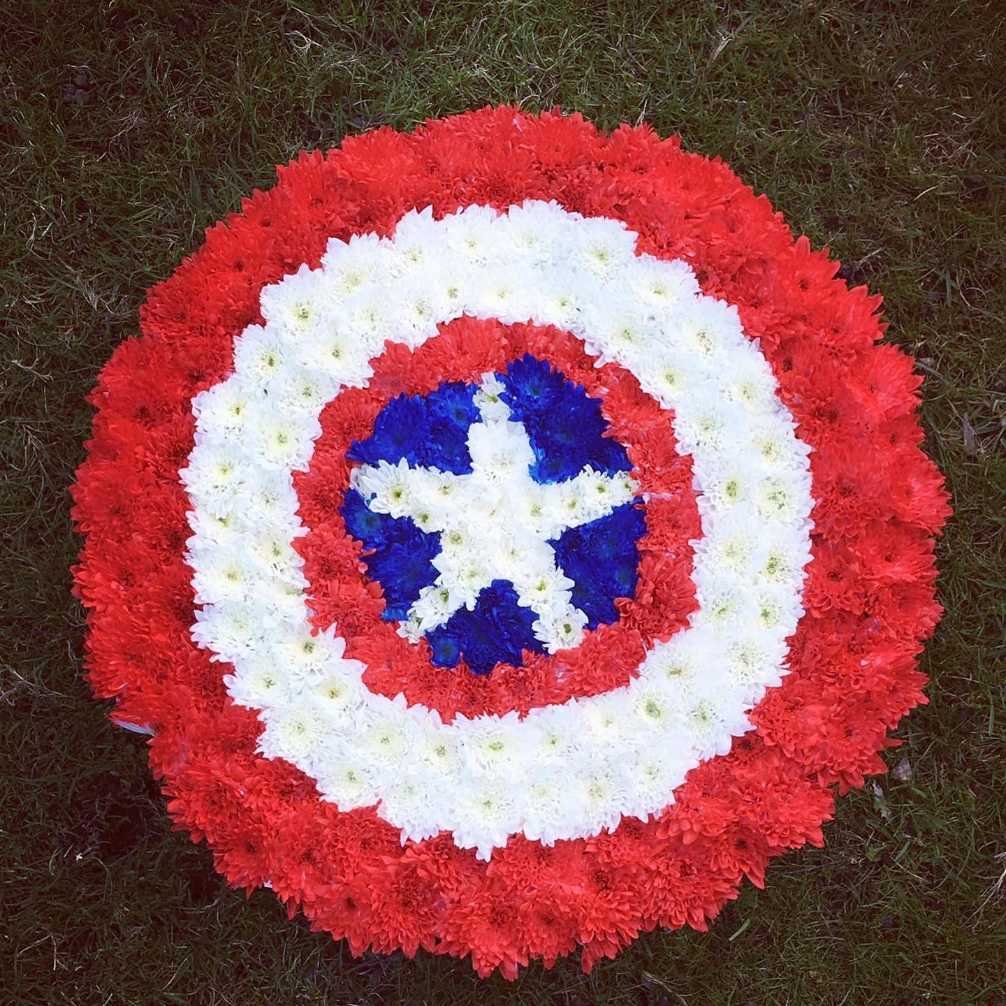 Bespoke Captain Americas Shield Funeral Tribute created by  Rachel's Country flowers who is a specialist funeral florist situated in the Scottish Highlands. Covering Edderton, Tain, Seaboard Villages, Balintore, Hilton, Fearn, Portmahomack, Invergordon, Alness, Dornoch, Golspie, Ardgay, Lairg. Lettering casket sprays, sheafs, posies and wreaths