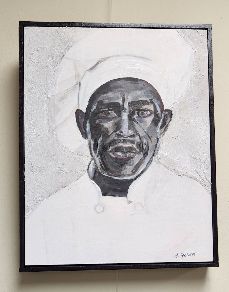 Black and white portrait of a chef wearing a hat and uniform; framed.