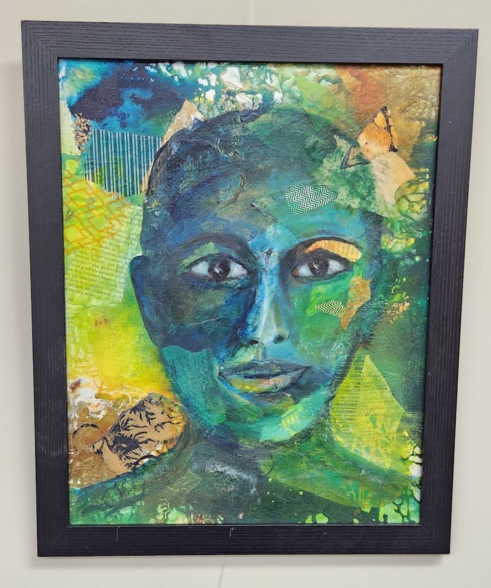 Abstract portrait in green and blue, framed.