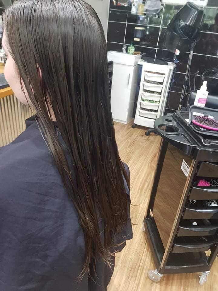 A Woman is Getting Her Hair Cut in a Salon — Eco Village Hair in Bongaree, QLD