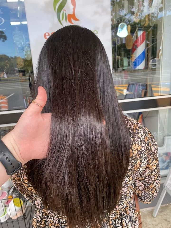 A Person Is Touching a Woman's Hair in A Salon — Eco Village Hair in Bongaree, QLD