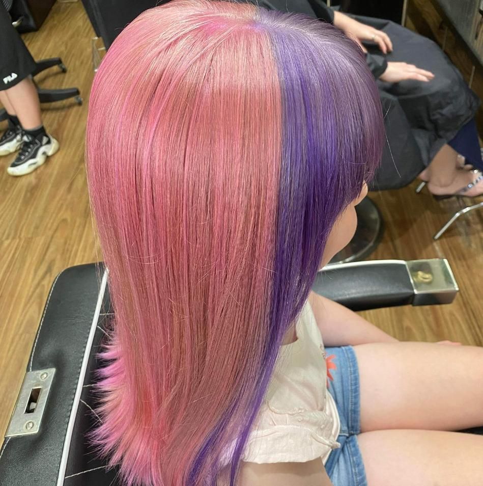 A Girl with Pink and Purple Hair Is Sitting in A Chair — Eco Village Hair in Bongaree, QLD