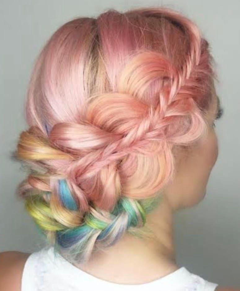 A Woman With Pink and Rainbow Hair is Wearing a Braided Bun — Eco Village Hair in Bongaree, QLD