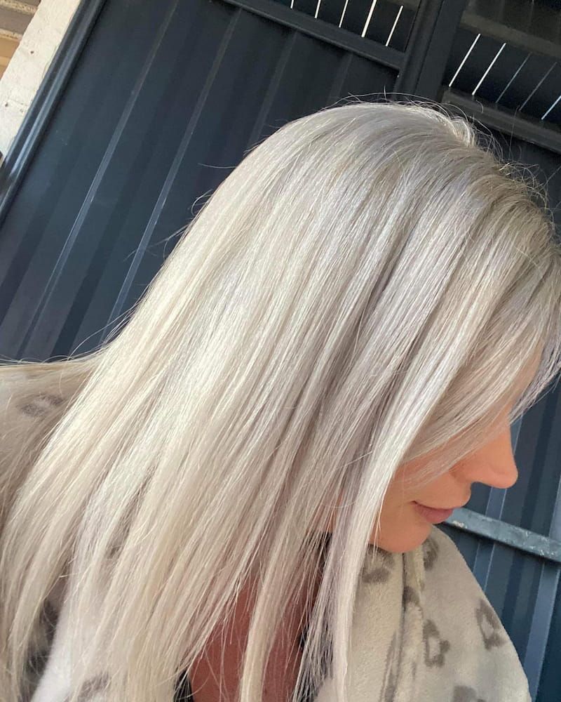 A Woman With Long Gray Hair is Wearing a Scarf — Eco Village Hair in Bongaree, QLD
