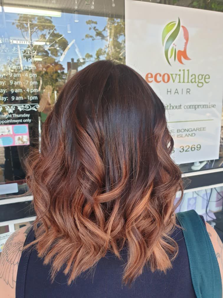 A Woman is Standing in Front of a Eco Village Hair Salon — Eco Village Hair in Bongaree, QLD