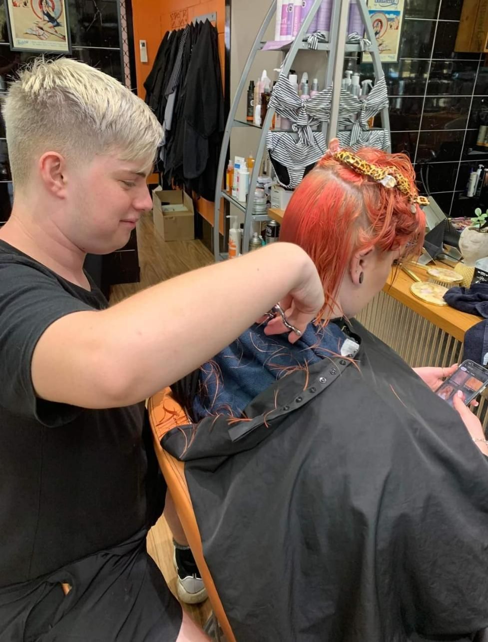 A Man Is Cutting a Woman's Hair in A Salon — Eco Village Hair in Bongaree, QLD