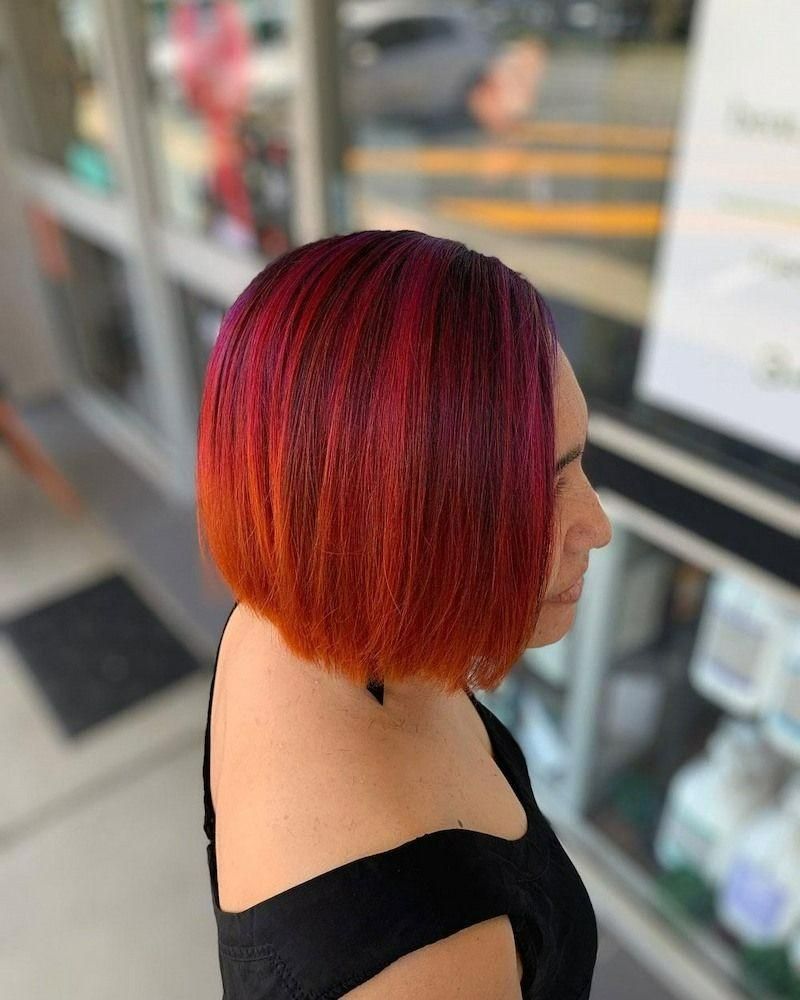 A Woman with Red Hair Is Wearing a Black Dress — Eco Village Hair in Bongaree, QLD