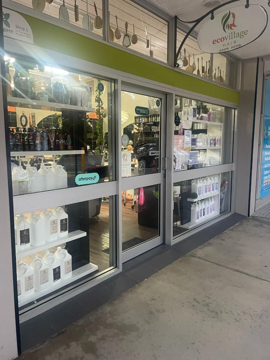A Store Front with A Lot of Shelves and Bottles in It — Eco Village Hair in Bongaree, QLD
