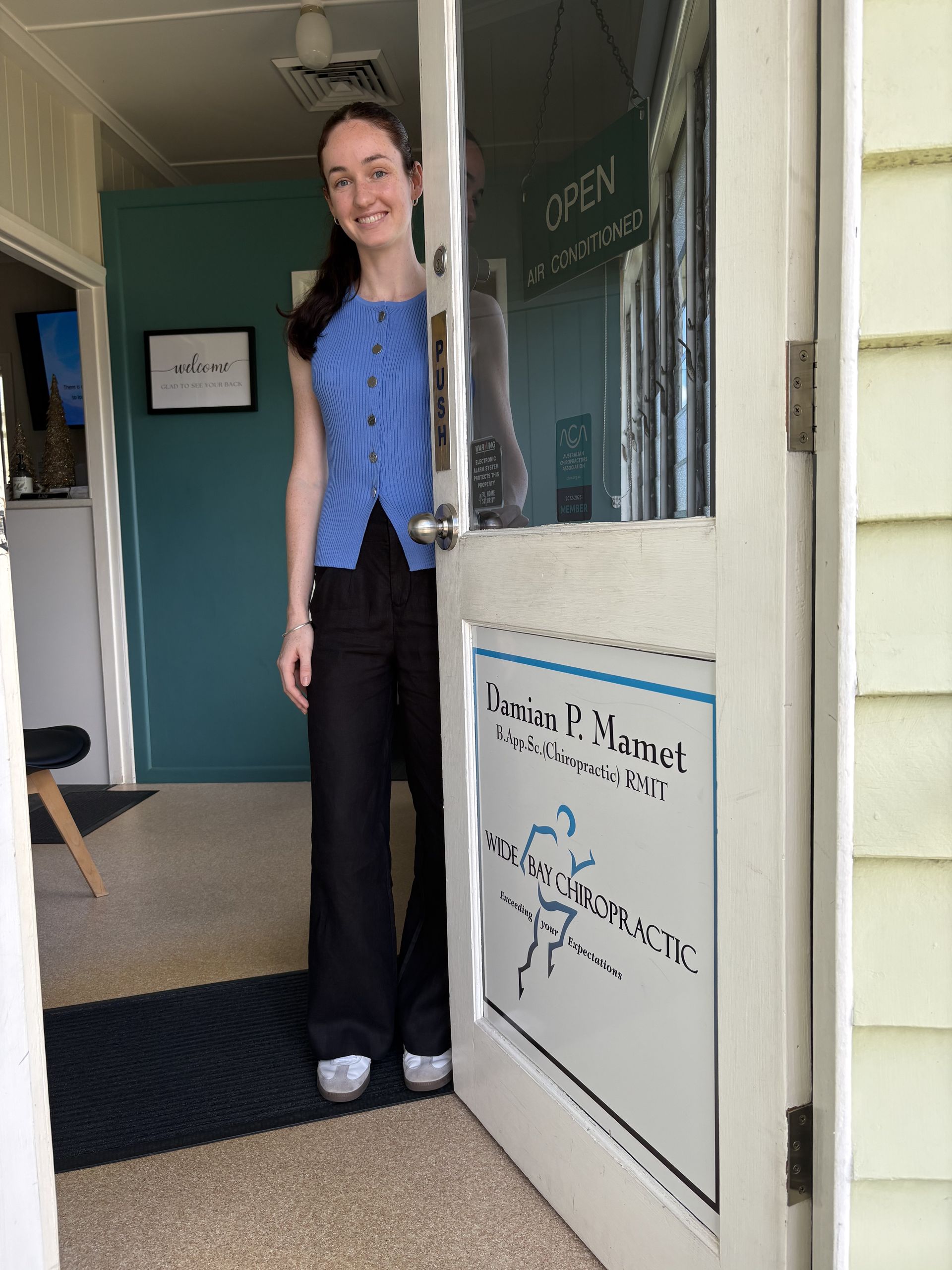 Woman Stands in Doorway of a Business — Wide Bay Chiropractic in Gympie, QLD