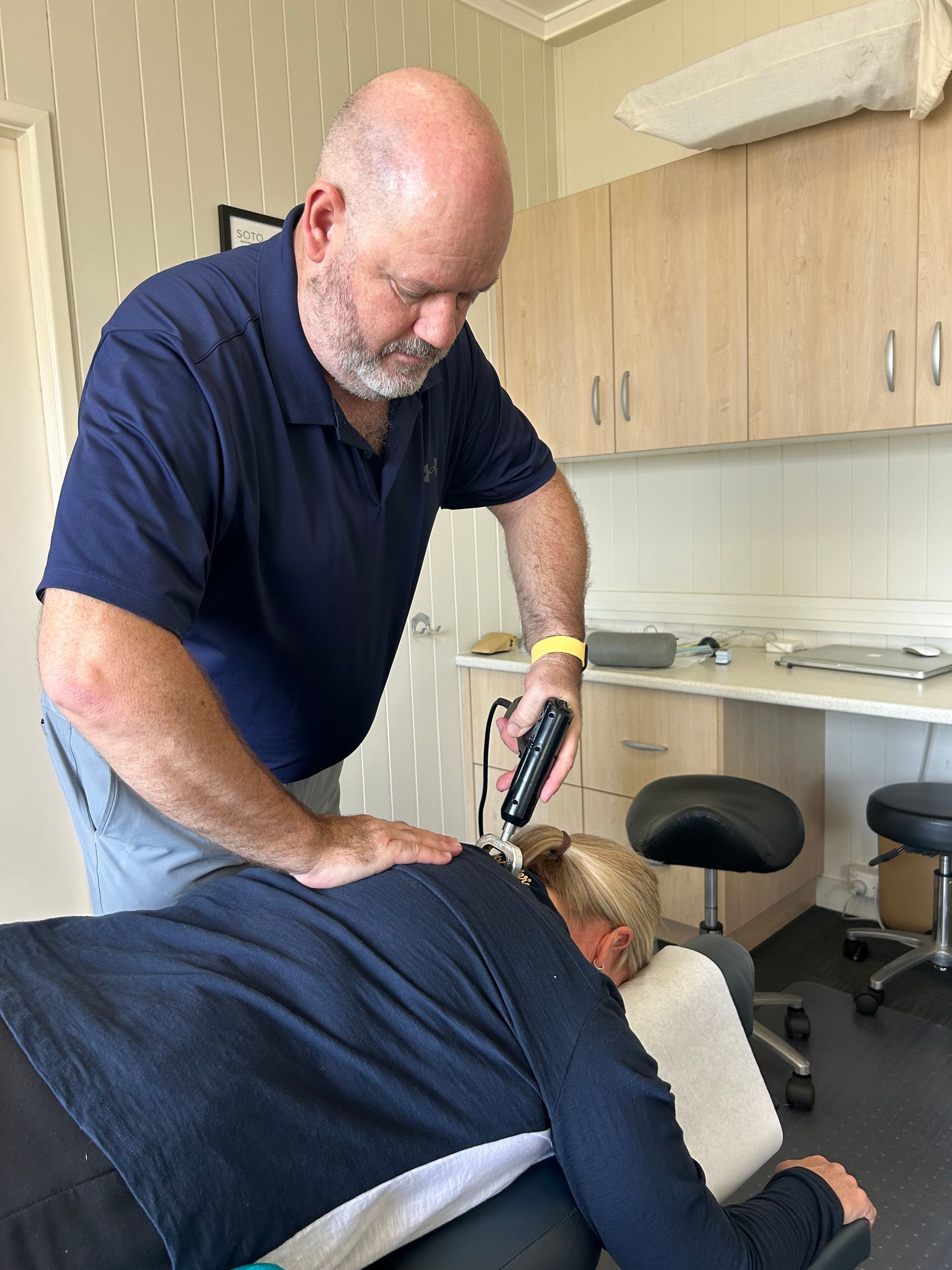 A Person Receives Physical Therapy on a Treatment Table — Wide Bay Chiropractic in Gympie, QLD