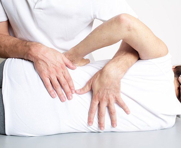 A Person Receiving Back Treatment From a Therapist in an Office Setting — Wide Bay Chiropractic in Gympie, QLD