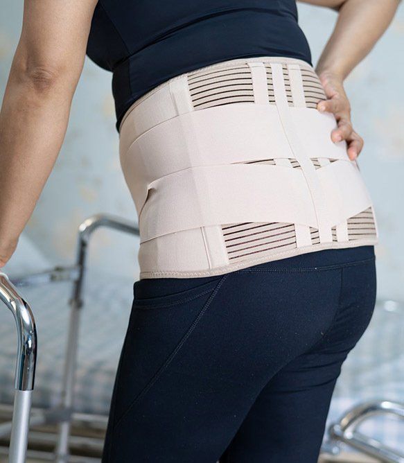Woman Wearing a Beige Back Brace — Wide Bay Chiropractic in Gympie, QLD