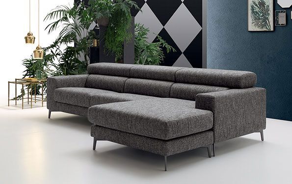 Divano componibile grigio con chaise longue in un soggiorno moderno.