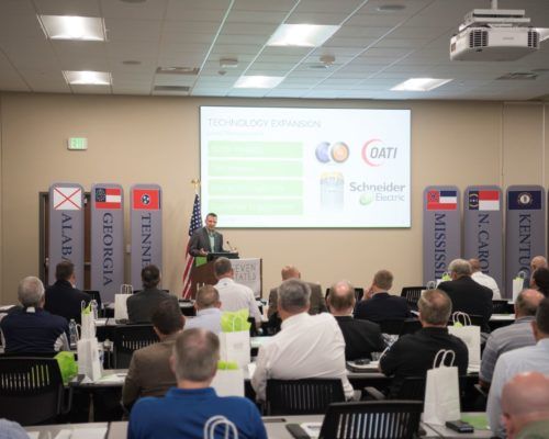 A man is giving a presentation to a group of people in a conference room.