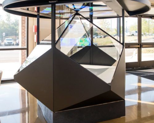 A large sculpture in a room with a lot of windows