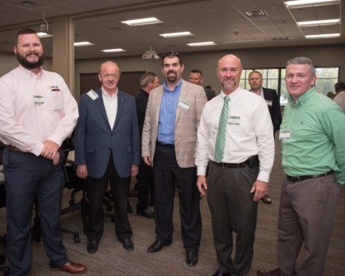 A group of men standing next to each other in a room