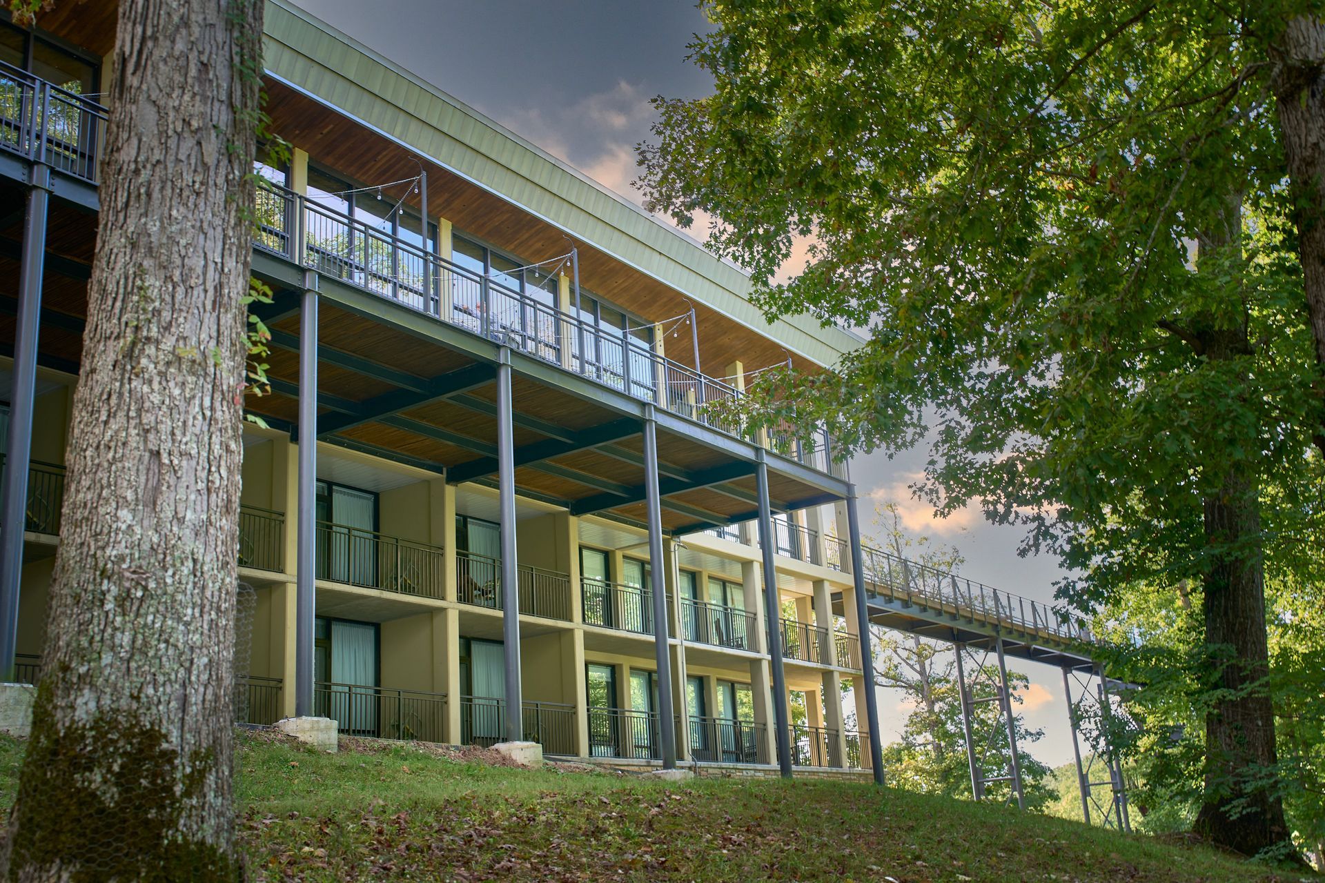 A large building with balconies and trees in front of it