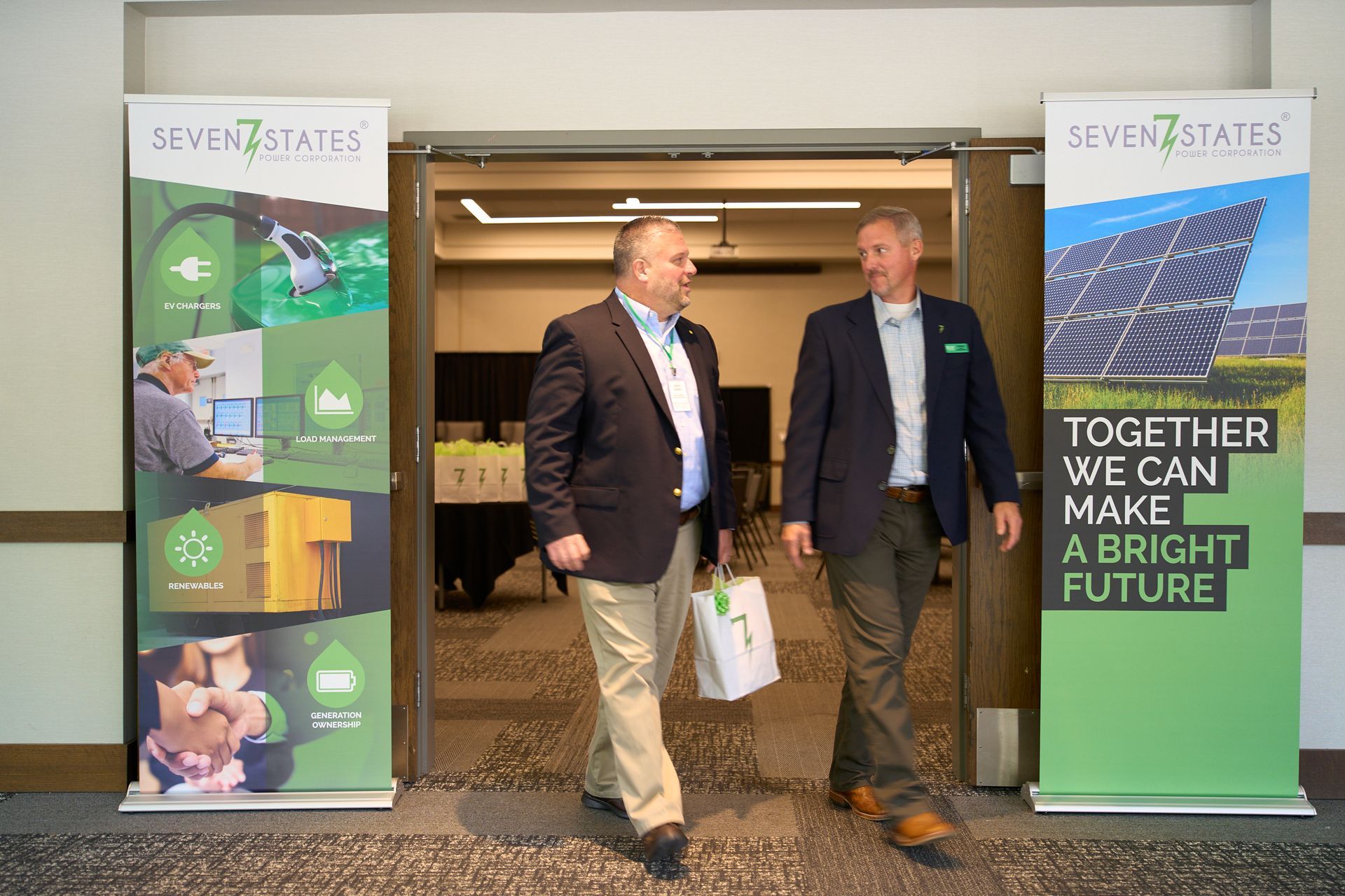 Two men are walking through a doorway next to a sign that says `` together we can make a bright future ''.