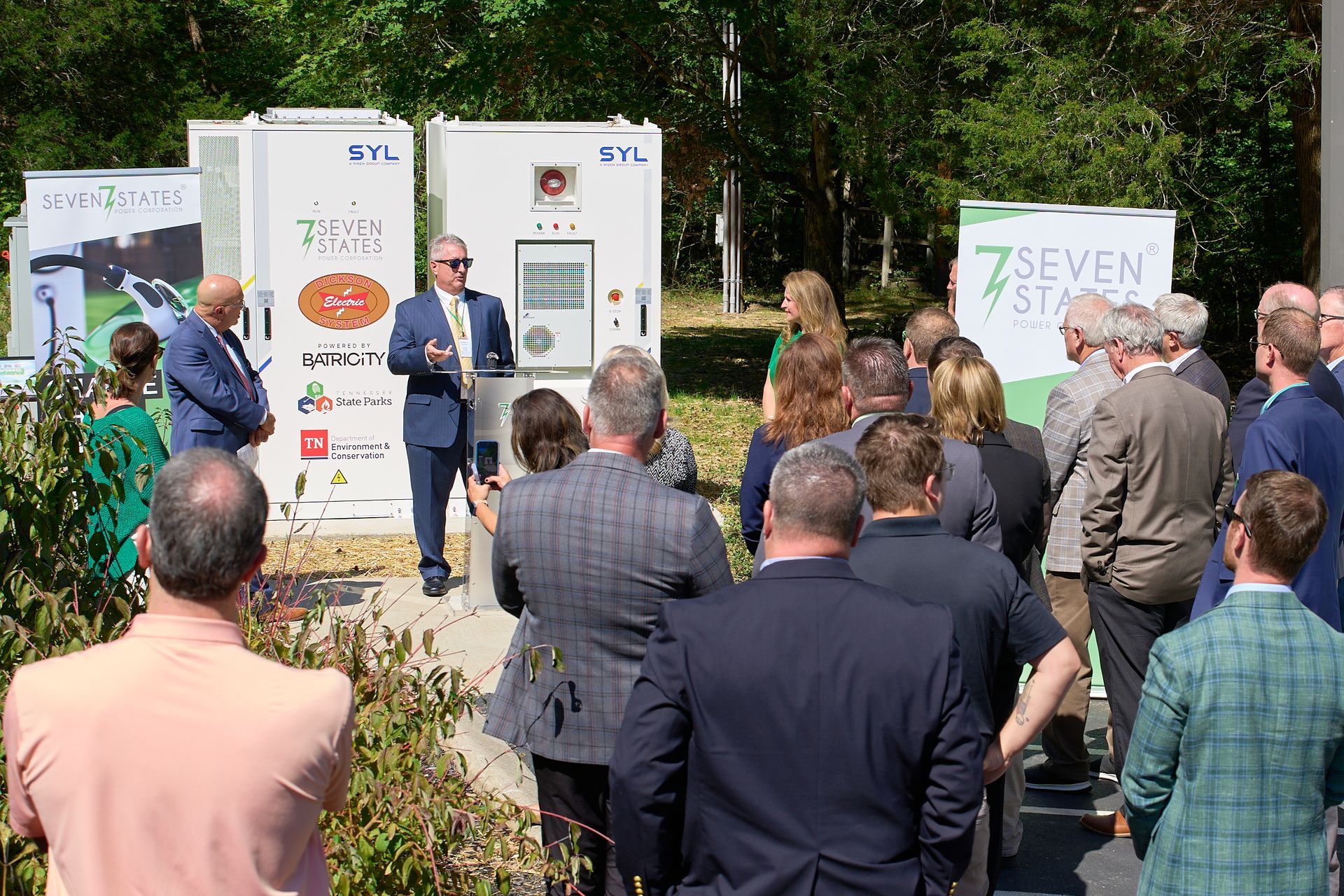 A group of people are standing in front of a podium.