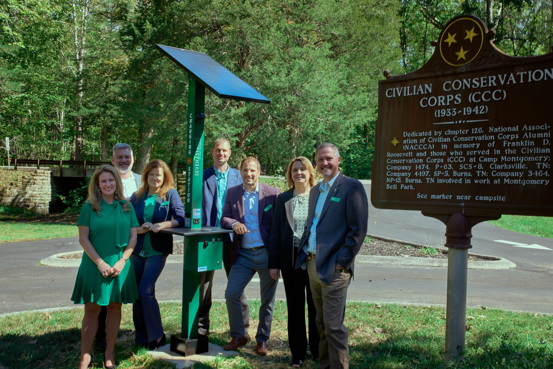 A group of people standing in front of a sign that says civilian conservation corps ilcci