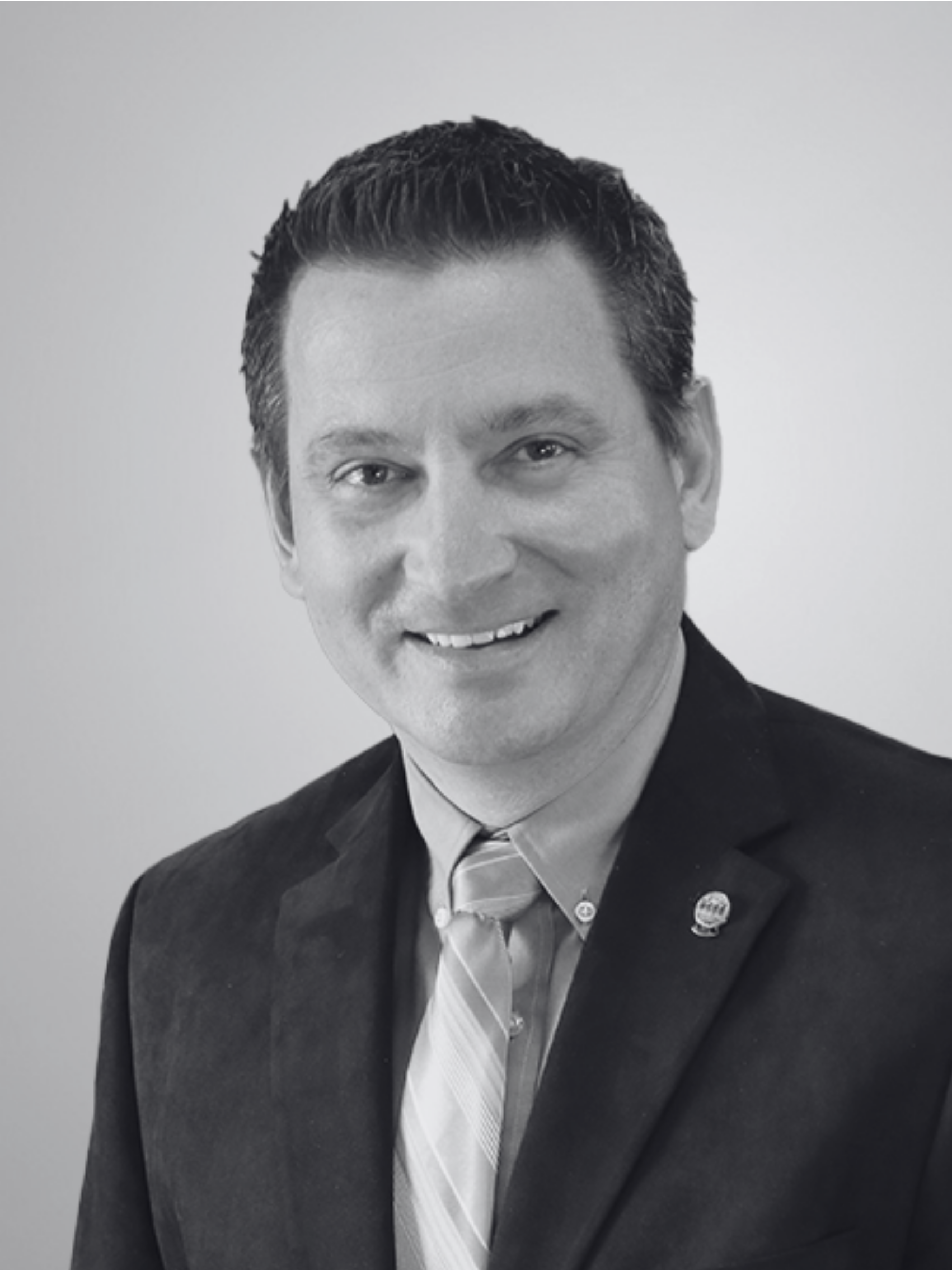 A black and white photo of a man in a suit and tie