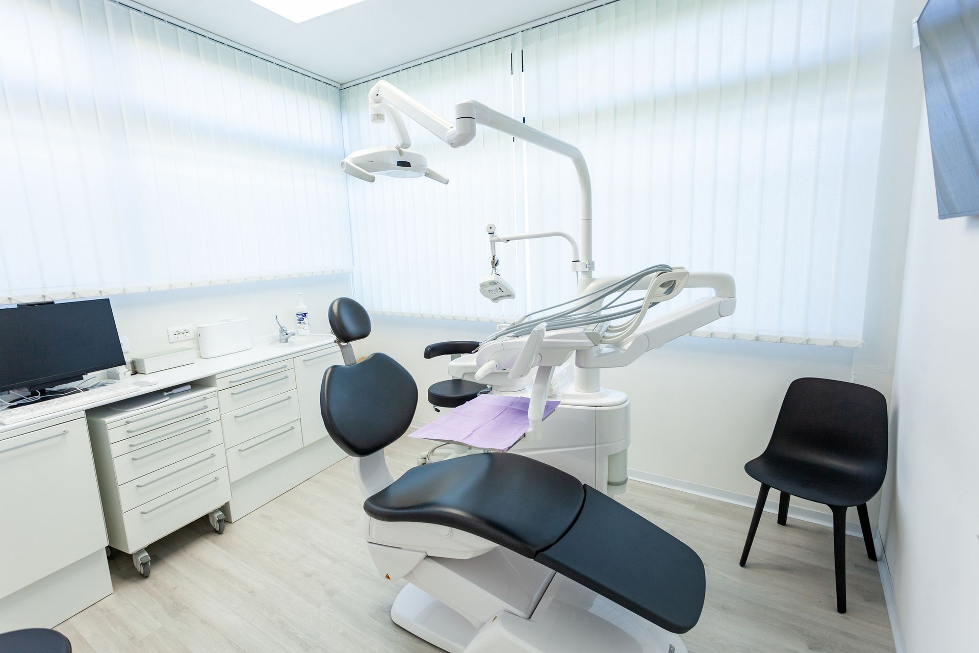 Empty dentist's office showing modern equipment.