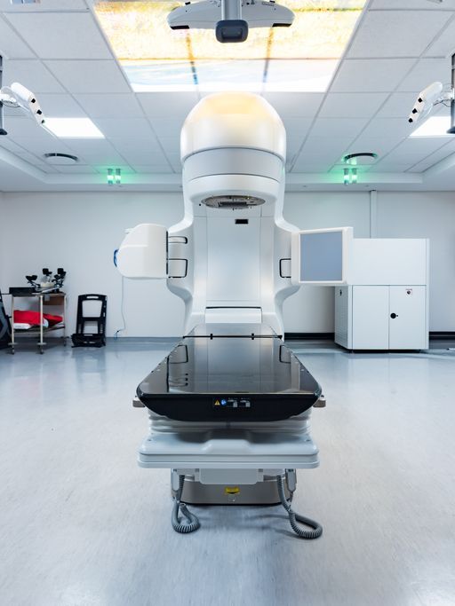 Medical room with a radiotherapy linear accelerator machine, moved by medical equipment movers. Medical room with a radiotherapy linear accelerator machine, moved by medical equipment movers.