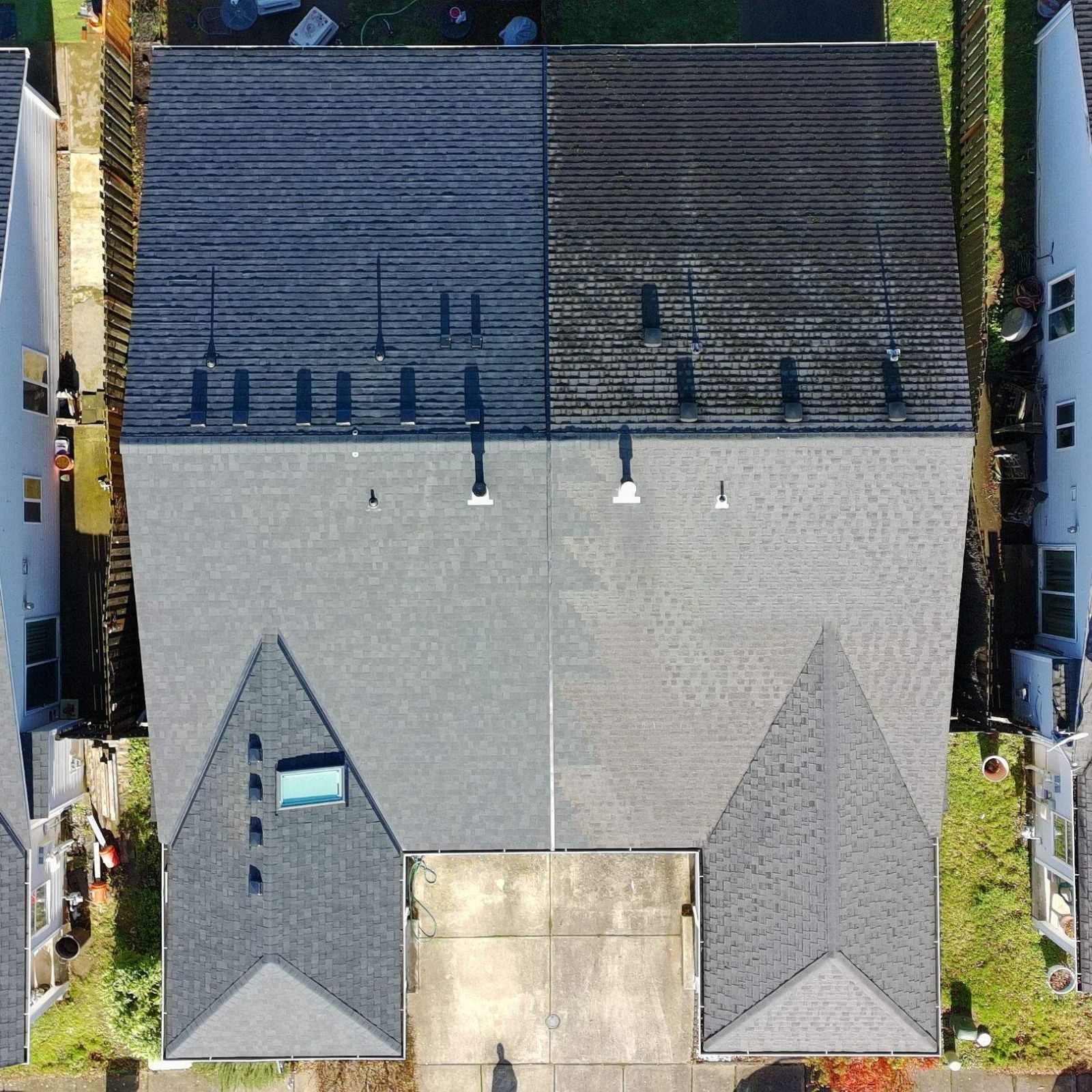 An aerial view of a multi-sectioned house roof with grey shingles, a section of red corrugated roofing, and a chimney.