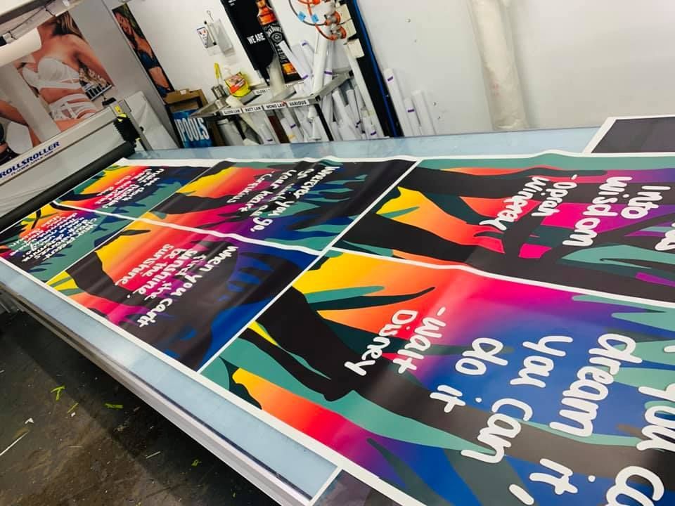 A Bunch Of Posters On A Table — Cairns Signcorp In Cairns, QLD