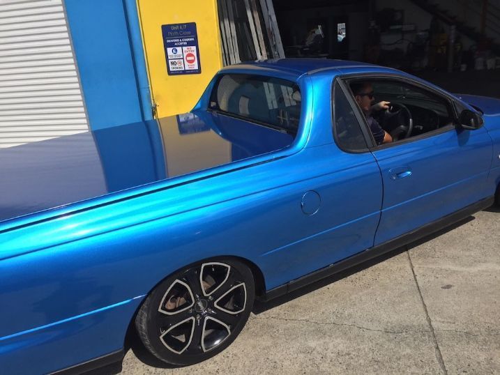 A Blue Pickup Truck Is Parked In Front Of A Building — Cairns Signcorp In Portsmith, QLD