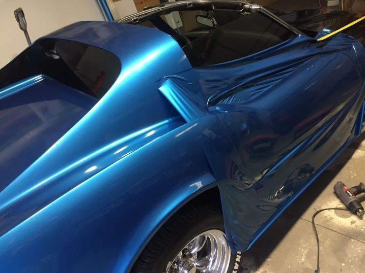 A Blue Car With Chrome Wheels Is Sitting In A Garage — Cairns Signcorp In Portsmith, QLD