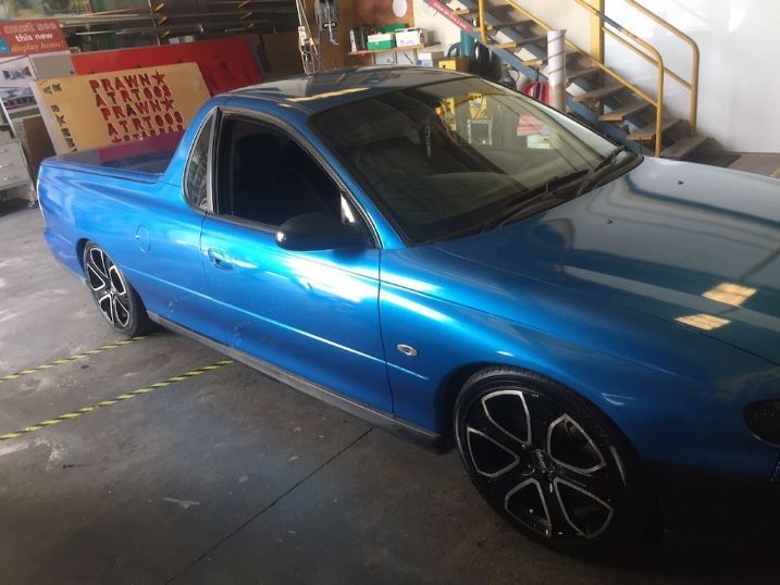 A Blue Pickup Truck Is Parked In A Garage — Cairns Signcorp In Portsmith, QLD