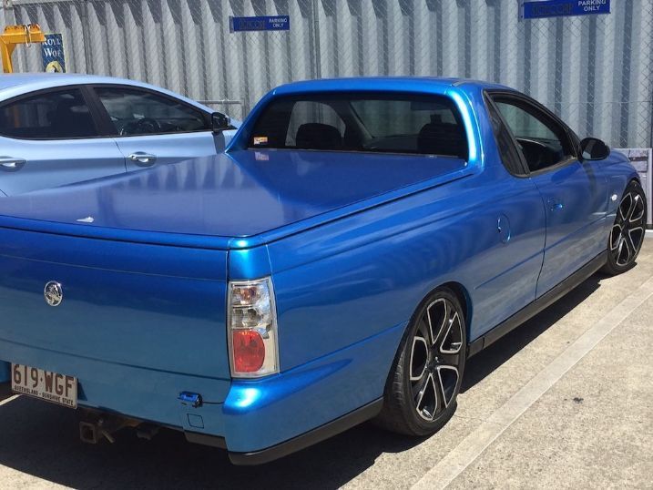 A Blue Pickup Truck Is Parked Next To A White Car — Cairns Signcorp In Portsmith, QLD