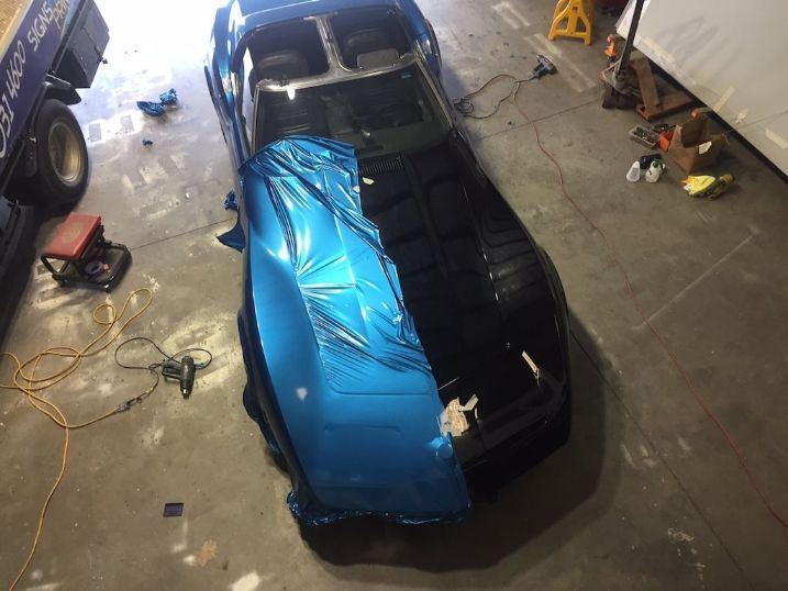 A Blue And Black Car Is Wrapped In Blue Foil In A Garage — Cairns Signcorp In Portsmith, QLD