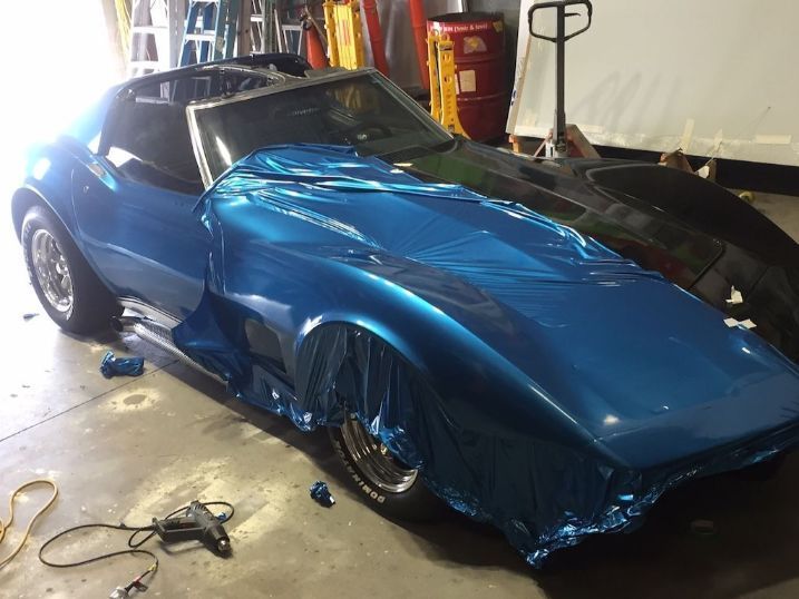 A Blue Corvette Is Wrapped In Blue Foil In A Garage — Cairns Signcorp In Portsmith, QLD