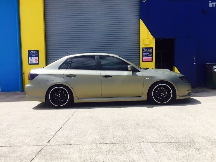 A Car Is Parked In Front Of A Blue And Yellow Building — Cairns Signcorp In Portsmith, QLD