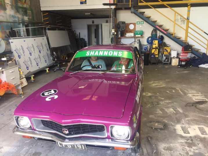 A Purple Car With A Green Shannons Sticker On The Windshield Is Parked In A Garage — Cairns Signcorp In Portsmith, QLD