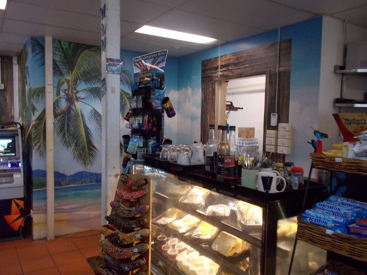 A Bakery With A Display Case And A Mural On The Wall — Cairns Signcorp In Portsmith, QLD