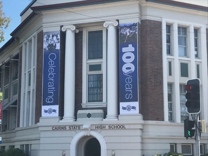 A Building With A Banner That Says 100 Years Celebrating — Cairns Signcorp In Portsmith, QLD