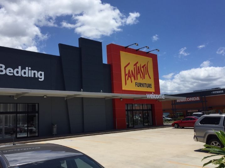 A Car Is Parked In Front Of A Fantastic Furniture Store — Cairns Signcorp In Portsmith, QLD