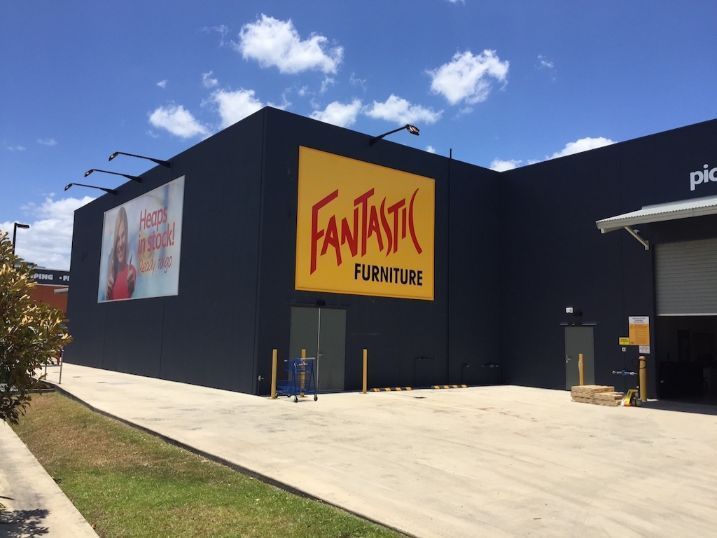 A Fantastic Furniture Store With A Large Yellow Sign On The Side — Cairns Signcorp In Portsmith, QLD