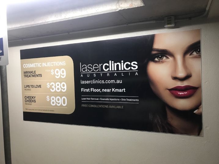 An Advertisement For Laser Clinics Australia With A Woman 's Face On It — Cairns Signcorp In Portsmith, QLD