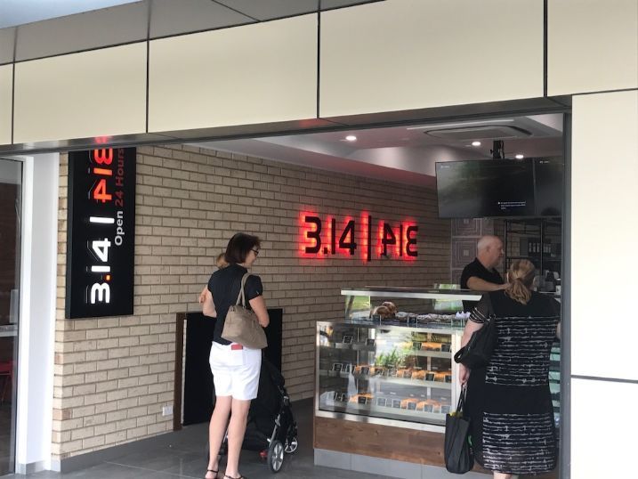 A Woman Is Standing In Front Of A 3.14 Pie Restaurant — Cairns Signcorp In Portsmith, QLD