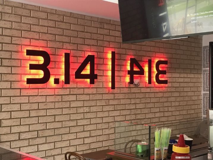 A Brick Wall With A Neon Sign That Says 3.14 Pie — Cairns Signcorp In Portsmith, QLD