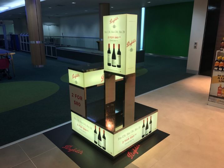 A Display Of Wine Bottles In A Store — Cairns Signcorp In Portsmith, QLD