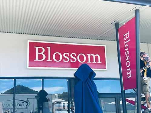 A Store Front With A Sign That Says Blossom On It — Cairns Signcorp In Portsmith, QLD