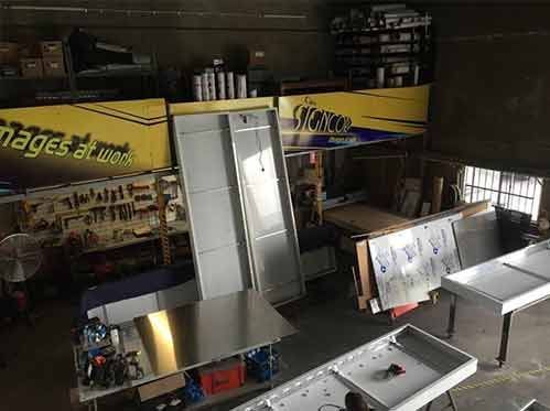 A Warehouse Filled With Lots Of Stainless Steel Pieces — Cairns Signcorp In Portsmith, QLD