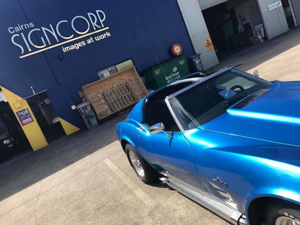 A Blue Car Is Parked In Front Of A Sign Corp Building — Cairns Signcorp In Portsmith, QLD