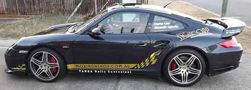 A Black Porsche 911 Turbo Is Parked On The Side Of The Road — Cairns Signcorp In Portsmith, QLD