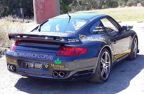 A Sports Car Is Parked On The Side Of The Road — Cairns Signcorp In Portsmith, QLD